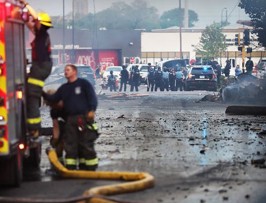 Image showing a firefighter and police in Minneapolis